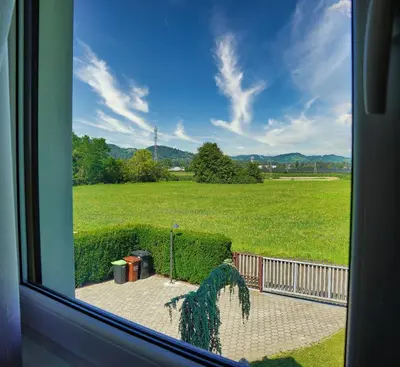 a view of a field from a window at Villa Vili - Jacuzzi, BBQ & EV Outlet in Limbuš