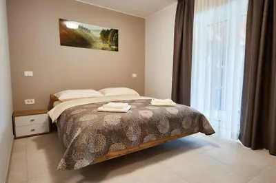 a bedroom with a bed with two towels on it at Posestvo Rouna - winery and apartments in Vipava