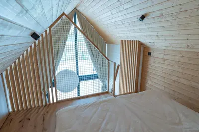 a bed in a room with a large window at Cabino - Fresh Air Resort in Bovec