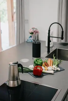 a plate of vegetables on a counter in a kitchen at Chalet HerMes arT in Idrija