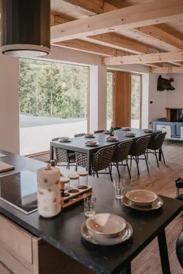 a large dining room with a table and chairs at Chalet HerMes arT in Idrija