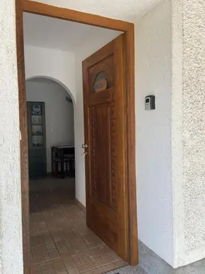a wooden door in a room with a hallway at Apartmaji SOČA in Most na Soči