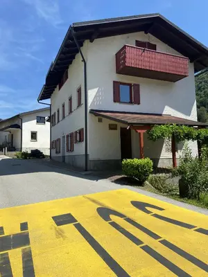 a yellow stop sign in front of a building at Apartmaji SOČA in Most na Soči