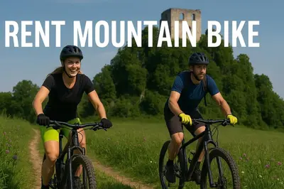 two men riding bikes down a dirt road with the words rent mountain bike at Green Oasis Garden in Šenčur