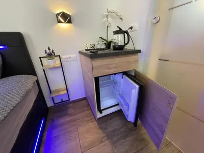 a small refrigerator under a counter in a room at Green Oasis Garden in Šenčur