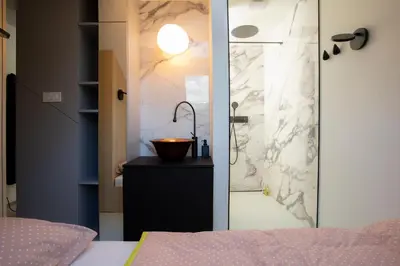 a bathroom with a shower with a sink and a counter at Studio Vilawin Kranjska Gora in Kranjska Gora