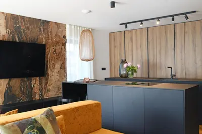 a kitchen with a counter and a couch in a room at Studio Vilawin Kranjska Gora in Kranjska Gora