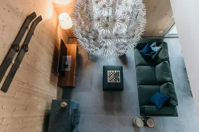 an overhead view of a living room with a couch and a chandelier at Janina's Dragonfly house in Nova Vas