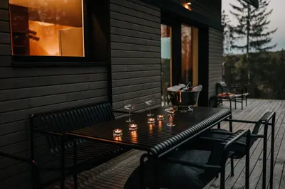 a table on a porch with candles on it at Janina's Dragonfly house in Nova Vas