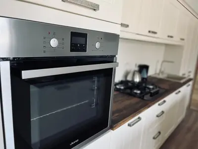 a kitchen with a black oven and a counter at Apartment Country House Zaton in Tišina