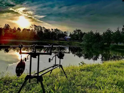 a camera on a tripod next to a lake at Apartment Country House Zaton in Tišina