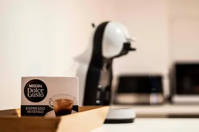 a desk with a cup of coffee and a lamp at Bled Lake Apartment House in Bled