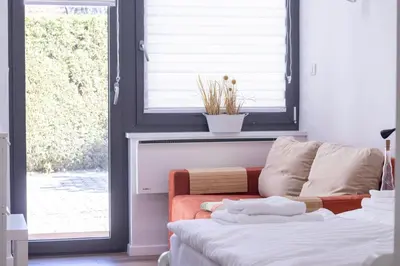 a living room with a couch and a window at Bled Lake Apartment House in Bled