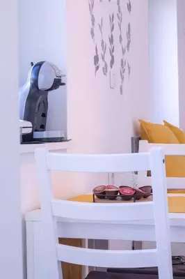 a white table and chair with dishes on a shelf at Bled Lake Apartment House in Bled