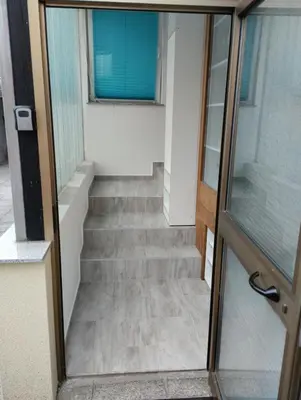 a stairway with a glass door leading up to a building at Blue Sun in Ljubljana