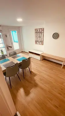 a living room with a table and chairs in a room at Blue Sun in Ljubljana