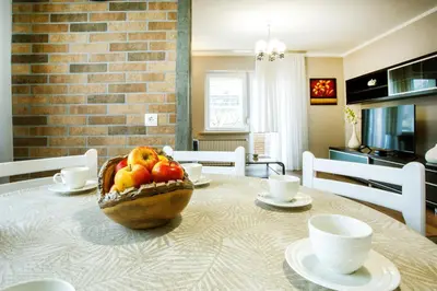 a table with a bowl of fruit on top of it at House Stepic in Sava