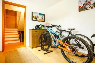 two bikes parked on a rack in a room at House Stepic in Sava