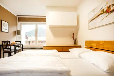 two white beds in a room with a window at House Stepic in Sava