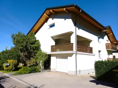a white building with wooden balconies on it at House Stepic in Sava