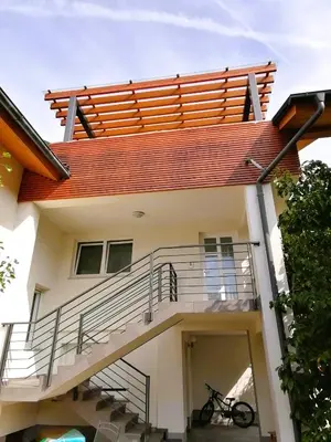 a house with a balcony and a bike parked in front at House Stepic in Sava