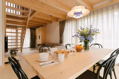 a dining room with a wooden table and chairs at PIRA HOTEL in Postojna