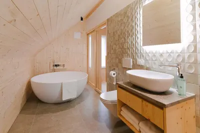 a bathroom with a white tub and a sink at PIRA HOTEL in Postojna