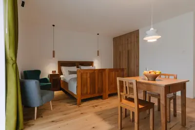 a bedroom with a bed and a table and a chair at PIRA HOTEL in Postojna