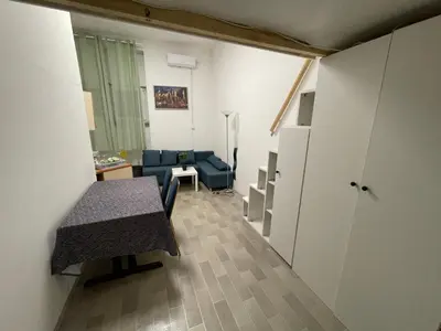 a living room with a blue couch and a table at ICE APARTMENT in Ljubljana