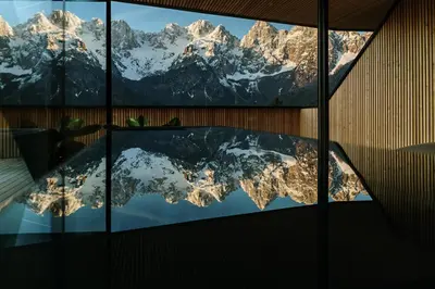 a reflection of the remarkables mountains in a window at Chalet Sofija in Gozd Martuljek