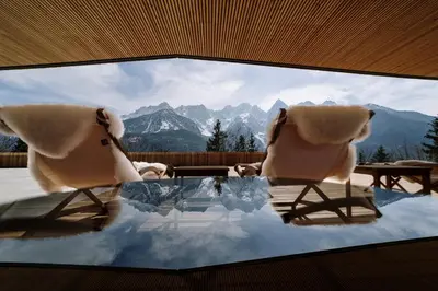 two chairs and a table with a view of mountains at Chalet Sofija in Gozd Martuljek