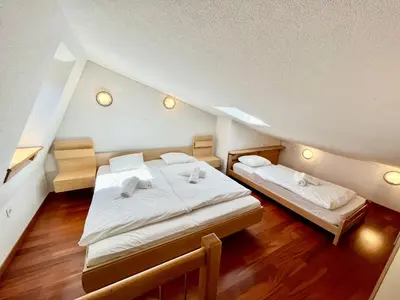 a attic bedroom with two beds in it at Apartment Anka in Bovec