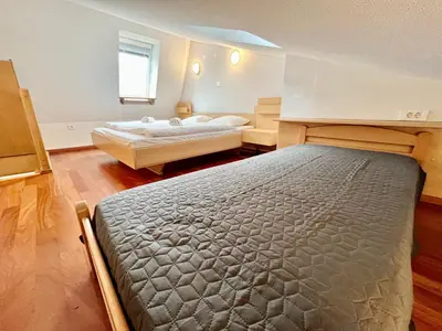 a bedroom with two beds and a window at Apartment Anka in Bovec