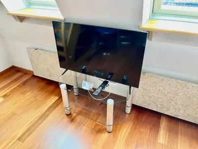 a computer monitor sitting on a stand in a room at Apartment Anka in Bovec