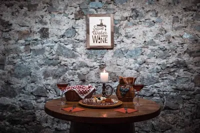 a table with a candle and two glasses of wine at Holiday home in Srednje Grcevje - Kranjska Krain 26095 in Srednje Grčevje