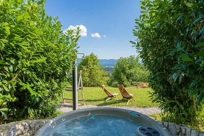 a bath tub in a garden with a chair at Holiday home in Srednje Grcevje - Kranjska Krain 26095 in Srednje Grčevje