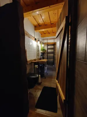 a hallway of a room with a desk and a table at POČITNIŠKA HIŠA PRLEČKA in Miklavž pri Ormožu
