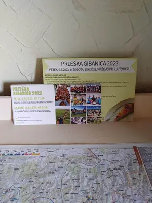 a shelf with two boxes and a map on it at POČITNIŠKA HIŠA PRLEČKA in Miklavž pri Ormožu