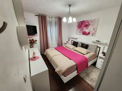 a bedroom with a large bed with a pink blanket at Apartma CIK in Bovec