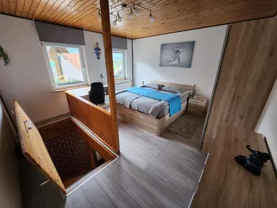 a bedroom with a bed and a staircase in a house at Apartma CIK in Bovec