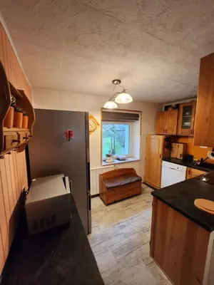 a kitchen with a refrigerator and a counter top at Apartma CIK in Bovec