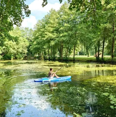 a person in a kayak on a river at Art house Tufi in Bistrica ob Sotli