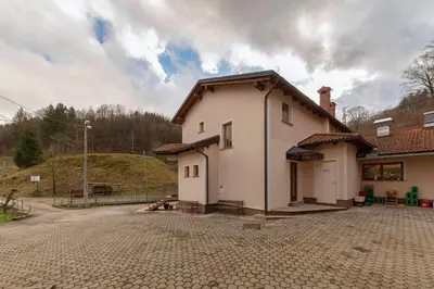 a small white building with a brick driveway at Farm Stay Ivankotovi in Prem