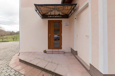 a building with a brown door and a sign on it at Farm Stay Ivankotovi in Prem