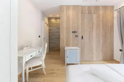a bedroom with a desk and a bed and a sliding door at Farm Stay Ivankotovi in Prem