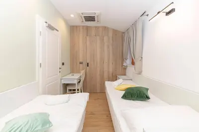 a room with two beds and a desk at Farm Stay Ivankotovi in Prem