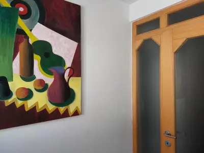 a painting of a vase on a wall next to a door at Domačija pri Ivankovih in Osilnica