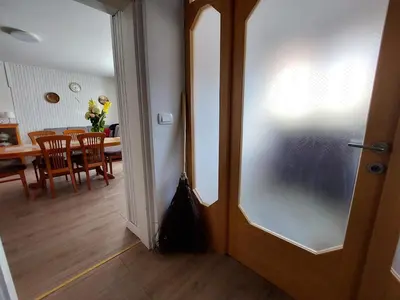 an open door to a dining room with a table at Domačija pri Ivankovih in Osilnica