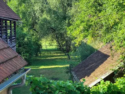 an overhead view of a garden with trees and a fence at Domačija pri Ivankovih in Osilnica
