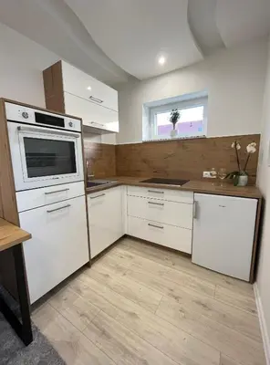 a kitchen with white appliances and a window at Luxe Apartments in Ljutomer